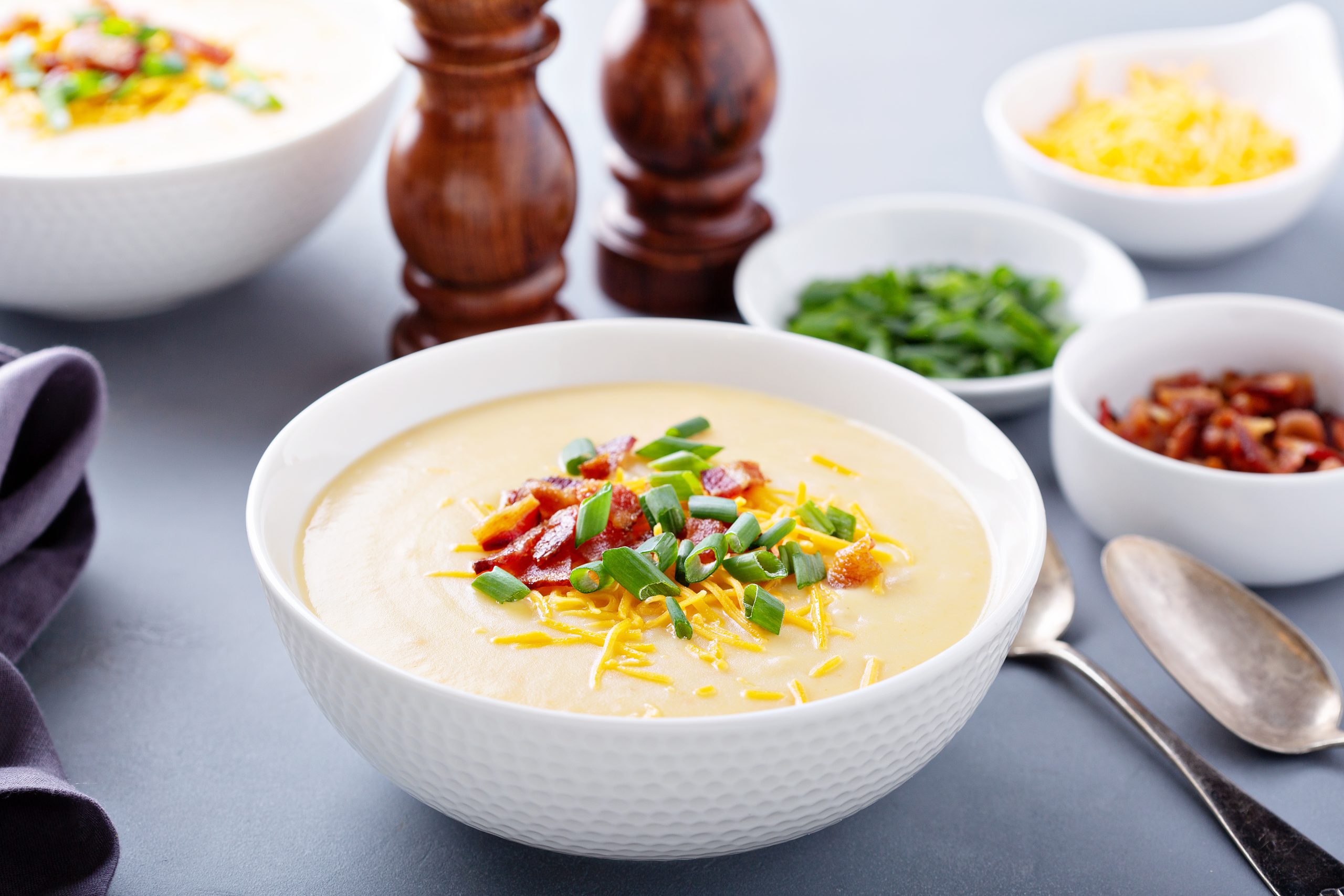 Potato cream soup with bacon, green onion and cheese